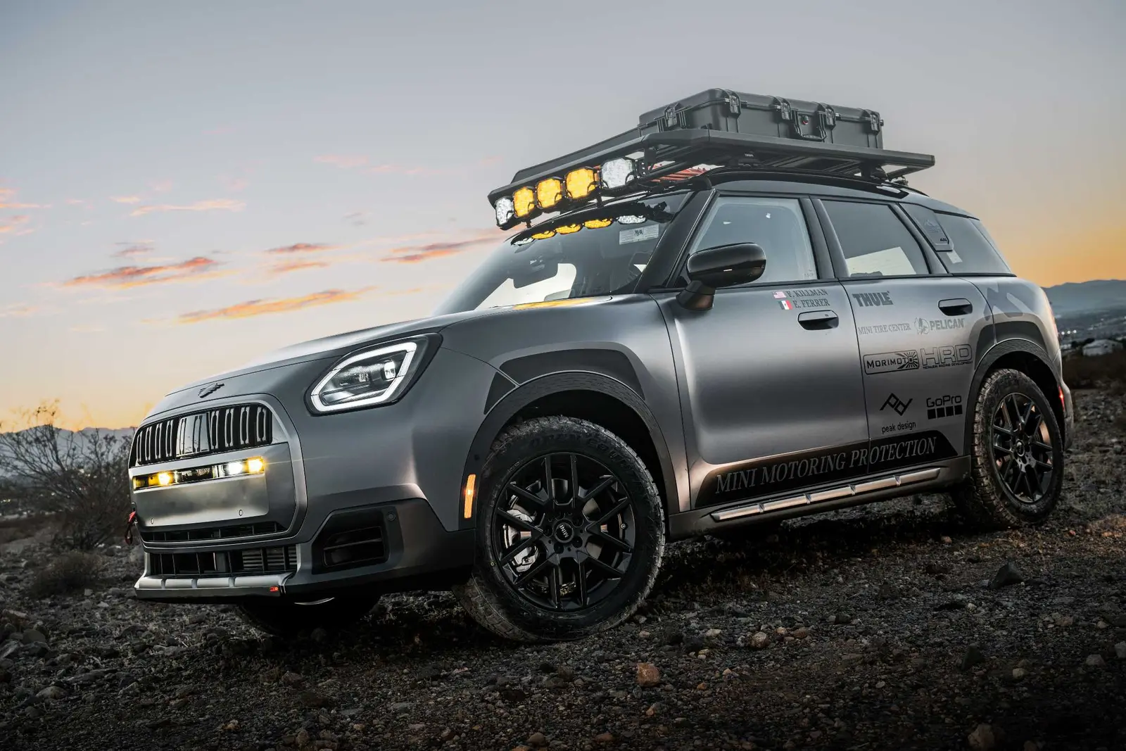 MINI Countryman Untamed Edition rally car with roof rack and lights at dusk